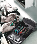 Mechanic using Compact 52 Piece Metric Bit Set With Textile Pouch Rapidaptor Quick Bit Change And 25 mm Torsion Bits For Long Life Pro Grade Build In Durable Surface Protecting Case.