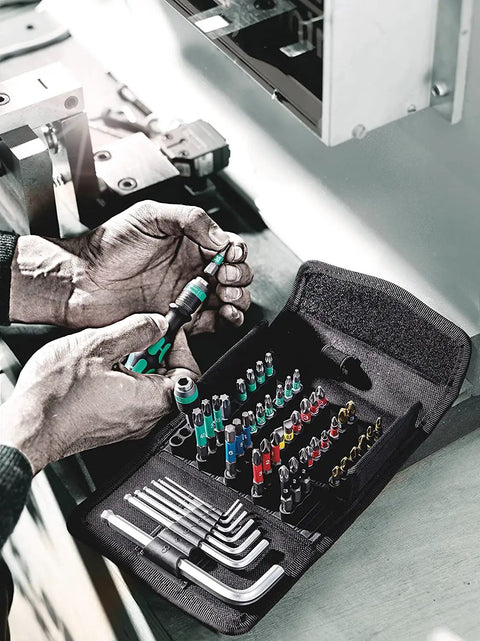 Mechanic using Compact 52 Piece Metric Bit Set With Textile Pouch Rapidaptor Quick Bit Change And 25 mm Torsion Bits For Long Life Pro Grade Build In Durable Surface Protecting Case.