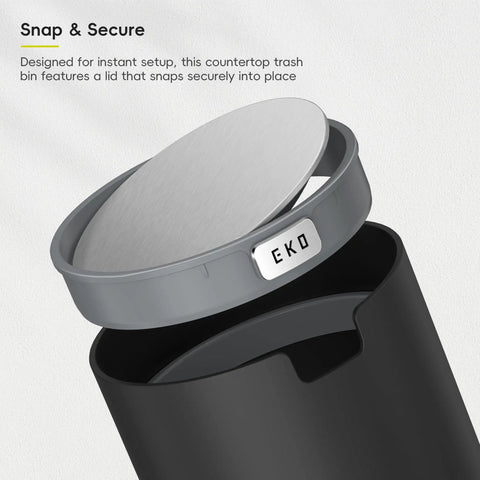 Compact Swing Top Mini Trash Can With Lid For Bathroom Vanity Countertop Desk Or Office 2.2L 7.3In Tall 5.3In Diameter Black Space Saver Tiny Trash Bin for Small Spaces showing lid snap feature.