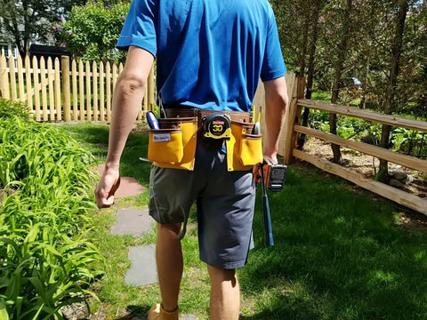 Man wearing 11 Pocket Suede Leather Heavy Duty Tool Belt Built Tough For Pros With Hammer Loops Measuring Tape Clip 4 Large Pouches