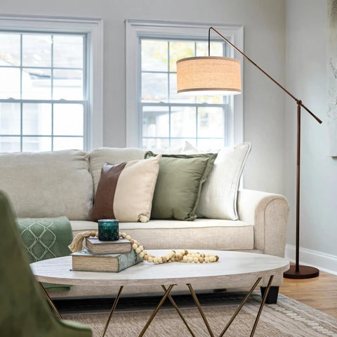 Tall Arc Floor Lamp With Sturdy Base In Rubbed Bronze LED Reading And Living Room Light Adjustable Arm For Dope Mid Century Modern Vibe Bedroom And Office Decor beside a sofa in a cozy living room setting.