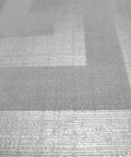 Close-up view of Modern Geometric Greek Key Wallpaper With Metallic Matte Finish, showcasing the gray silver texture.