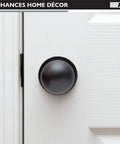 Oil Rubbed Bronze Interior Passage Door Knob installed on white door for halls and closets, non-locking, left or right hand use.
