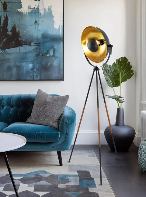 Lit Modern Tripod Floor Lamp in black finish with gold foil shade and leather legs, 58-inch tall, mid-century style in living room