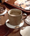 Premium Round Cowhide Coasters Set Of Twelve Natural Leather Drink Mats Ultra Smooth Finish used with a mug on a wooden table.