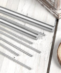 Four Pieces 10 Mm By 305 Mm 304 Stainless Steel Rods For DIYers And Model Makers on wooden surface