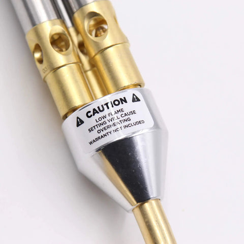 Close-up detail of the Triple Head MAPP Torch With Metal Body, showcasing the warning label and metal construction.