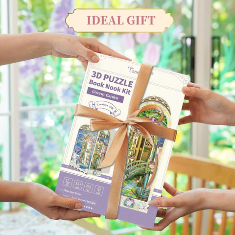 Hands holding a wrapped DIY Book Nook Kit For Grownups 3D Wooden Miniature House Puzzle With LED Lights Dust Cover And Bookend Insert