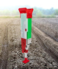 Handheld Garden Seeder And Planter Tool For Quick, Precise Sowing Of Corn, Beans, Peas And Veggies in a plowed field