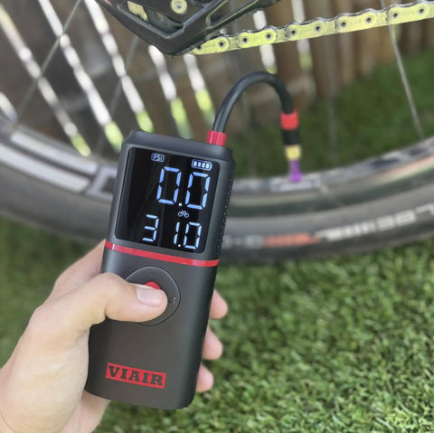 Slick Rechargeable Tire Inflator And Portable Air Compressor Featuring Digital Led Display and Automatic Shutoff, showing pressure gauge and hose.