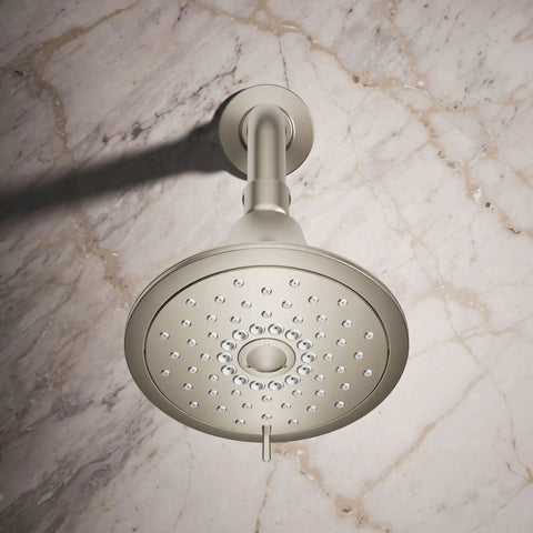 Forté Three-Function Showerhead With Full Coverage, Pulsating Massage And Silk Spray, installed against a marble wall