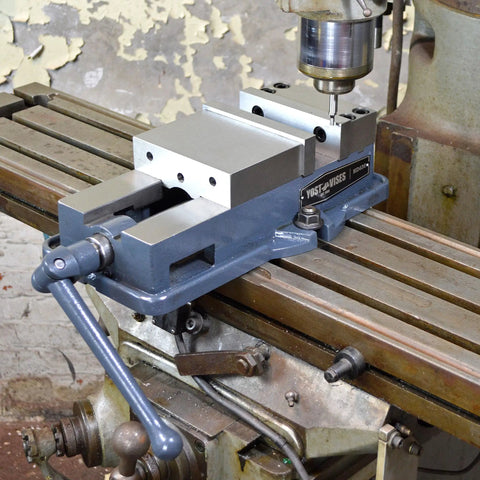 Heavy Duty 6 Inch Milling Machine Vise Crafted From Tough Ductile Iron With Hardened Steel Smooth Jaws on a CNC mill table.