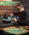 Heavy Duty Laser Safety Goggles Delivering Serious Eye Protection Against Hazardous Beams For Welding Marking Cleaning And Machine Shops Featuring Real Talk Anti Glare Coatings And Polycarbonate Shields That Are Actually Built Different worn by a man using a laser engraving machine.