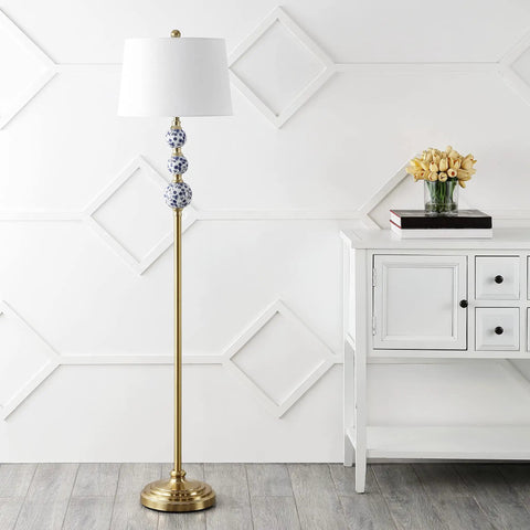 Bold Brass Gold And Blue Midcentury Ceramic Floor Lamp With Hand Painted Porcelain And White Linen Shade Coastal Classic Style LED Bulb Included For Effortless Bright Ambience next to a white cabinet