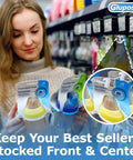 Woman shopping with clear pegboard clips for 1/4 peg hooks and slatwall holding baby bottles on retail shelf