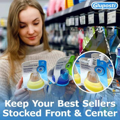 Woman shopping with clear pegboard clips for 1/4 peg hooks and slatwall holding baby bottles on retail shelf