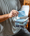 Person holding Granat PRO Fine Profile Sanding Sheets 3x4 Inches 80x133 mm 10 Pack with foam backing on staircase