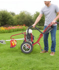 Person using 63Cc 4Hp Gas Powered Tiller Cultivator 3 In 1 Hand Push Micro Cultivator for lawns with front spiral blades.