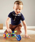 Child playing with Cycle STEM Kit For Hands On Learning And Fine Motor Skills, 30 Piece Toddler Explorer Set on wooden floor.