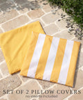 Outdoor Pillow Covers Set Of 2 18x18 Waterproof Throw Pillow Covers for Porch and Patio, yellow and striped design on stone surface.