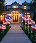 Lit Patriotic Solar Flag Lights For Outdoors, 8 Pack Pathway Stakes With 8 Modes, illuminating a house walkway at night.