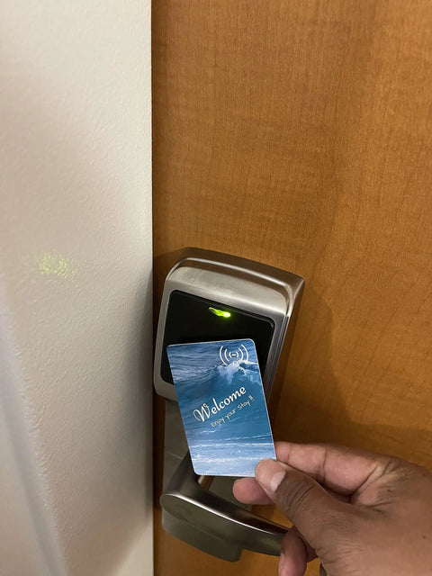 Person using Touchless RFID Hotel Key Cards Bulk 200 Pack Rewritable For Hospitality Use, Compatible With MIWA ILCO at door lock