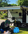 Person welding with Heavy Duty Welder Adapter Cord 50 Amp NEMA 14-50P To 6-50R RV Plug near an RV trailer.