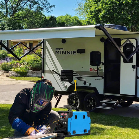 Person welding with Heavy Duty Welder Adapter Cord 50 Amp NEMA 14-50P To 6-50R RV Plug near an RV trailer.