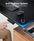 Man adjusting Electric Height Adjustable Standing Desk 48 By 24 Inches With Ergonomic Sit Stand Design, black top, anti-collision feature.