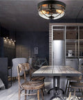 Industrial Black 13 Inch Flush Mount Ceiling Light With Seeded Glass Shade And Metal Cage in a vintage style kitchen setting.