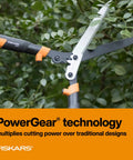 23 Inch Hedge Shears With PowerGear2 Technology trimming branches, showing sharp blades in garden setting