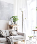 Two Light Mother Daughter Floor Lamp With White Marble Glass Shades In Brushed Nickel Finish next to a grey sofa in bright room