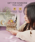 Person holding Starry Night 3D Puzzle Music Box Kit For Adults And Teens with rotating colorful orbs on display.