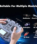 Hands holding Boxer ELRS 2.4GHz 16 Channel Hall Gimbals Radio Controller With Carrying Case, transparent white. 