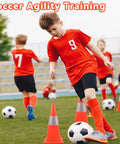 Boys practicing soccer agility around Top Notch High Visibility 15 Inch Traffic Cones With Reflective Collars on field