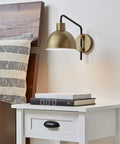 Vintage Industrial 1 Light Wall Sconce Plug In Or Hardwire With Antique Brass And Matte Black Accent next to bed