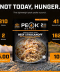 Hearty Beef Stroganoff Freeze Dried Backpacking Meal Just Add Water Made With Real Meat in a lightweight package on rocky surface.