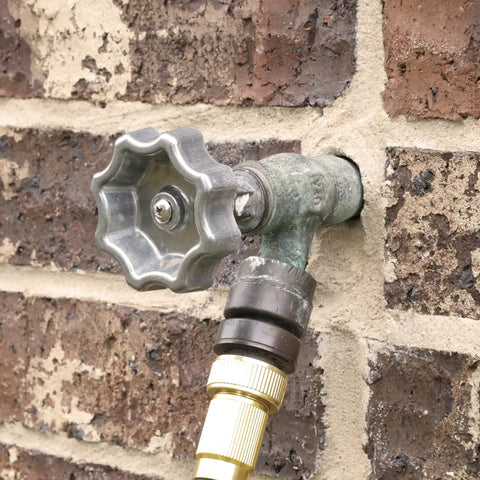 Outdoor Faucet Handle Replacement Round Wheel Spigot for Hose Bibb Leaky Outdoor Faucets Metal Silver Pewter on brick wall