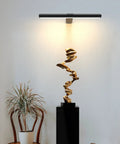 Rechargeable Magnetic LED Picture Light With Remote Dimmable Wall Art Lighting illuminating gold sculpture on pedestal