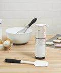 Two Cup Adjustable Measuring Cup With Grippy Rotating Body For Easy Pouring Of Peanut Butter And Honey on kitchen counter