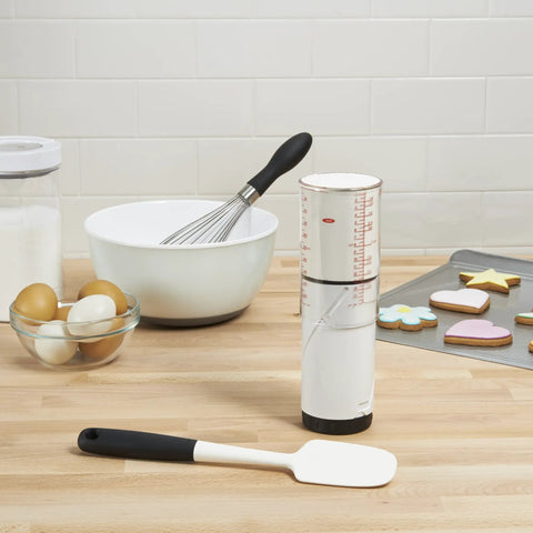 Two Cup Adjustable Measuring Cup With Grippy Rotating Body For Easy Pouring Of Peanut Butter And Honey on kitchen counter