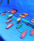 Pro Grade Hardened Steel Torx Drivers 25 Piece Assorted Sizes T9 To T40 Heavy Duty Repair Kit For Mechanics And Handymen arranged on a blue surface.