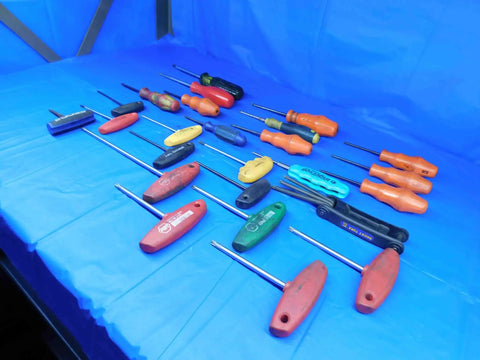 Pro Grade Hardened Steel Torx Drivers 25 Piece Assorted Sizes T9 To T40 Heavy Duty Repair Kit For Mechanics And Handymen arranged on a blue surface.