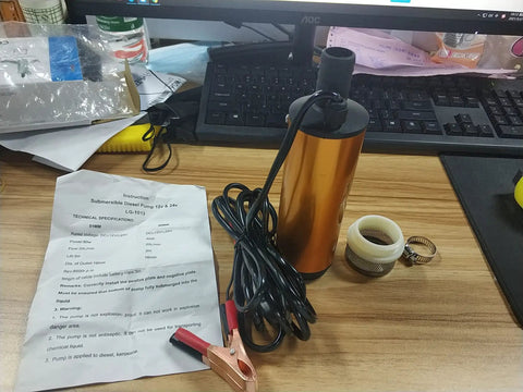 Beefy 12V Submersible Water Transfer Pump with accessories on desk, ideal for diesel kerosene and water, featuring stainless steel shell