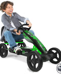 Child riding a green pedal go kart for kids with durable steel frame and easy pedal power, promoting safe outdoor fun.
