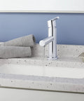 Parma Single Handle Lavatory Faucet With Metal Touch Down Drain on speckled countertop with modern bathroom decor