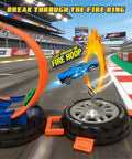 Transformable Tire Race Track Set For Kids 3 To 8 With Portable Handle Double Track Course 360 Degree Loops Two Racing Cars Awesome Racing Toy Playset Birthday Gift For Boys And Girls showing a car leaping through a fire hoop.