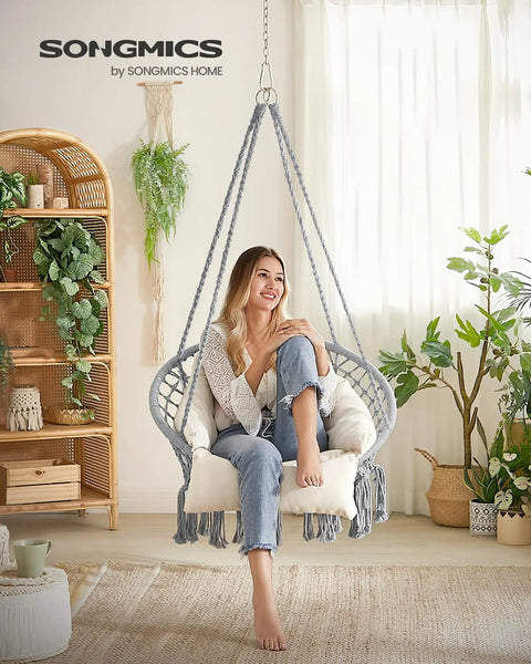 Woman sitting in Comfy Hammock Chair With Large Thick Cushion, Boho Swing Chair For Bedroom, Patio Or Garden, Dove Gray And Cream White