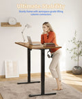 Person using Electric Standing Desk 48 By 24 Inches With Adjustable Height, Large Splice Board, Black Frame And Rustic Brown Top