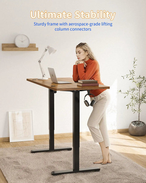 Person using Electric Standing Desk 48 By 24 Inches With Adjustable Height, Large Splice Board, Black Frame And Rustic Brown Top